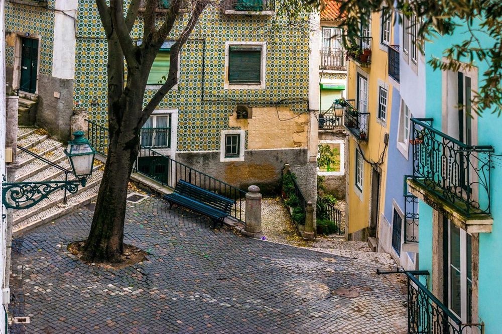 Street and cobblestone floor in the old neighborhood of Alfama, Lisbon ©  David Evora Marquez/Shutterstock