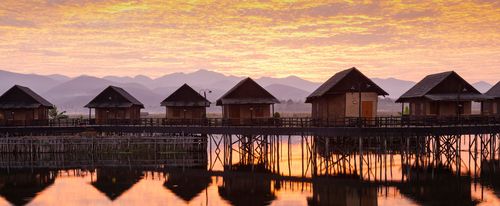 Sunrise and hotel cabins over Inle Lake