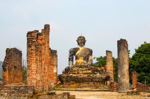 Ancient buddha statue and columns of the buddhist temple of Wat Phia Wat destroyed in the Vietnam war, Muang Khoun, Xieng Khuan