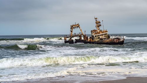 Skeleton Coast in Namibia. The shipwreck was stranded or grounded at the coastline of the Atlantic close to Swakopmund © gg-foto/Shutterstock