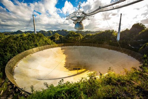 Large radio telescope dish in Arecibo national observatory © Photo Spirit/Shutterstock