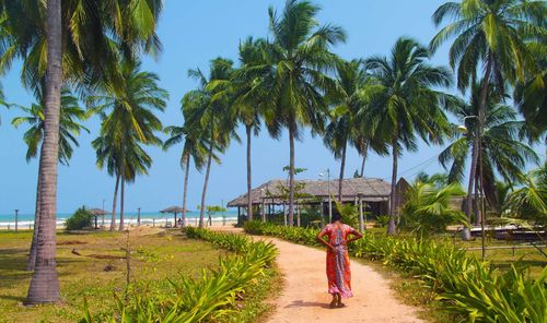Trincomalee, Sri lanka woman in beautiful sari walking toward beautiful Nilaveli beach ©  Sergii Rudiuk/Shutterstock