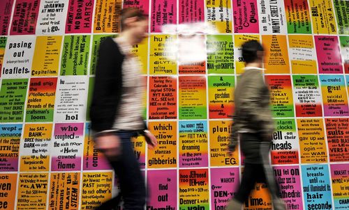 Visitors walk past 'The singing posters I-III' by US artist Allen Ruppersberg at the William S. Burroughs exhibition at the ZKM in Karlsruhe, Germany.