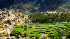The beautiful mountain village of Balad Sayt sits in front of green fields in Wadi Bani Awf, Oman © Kylie Nicholson/Shutterstock