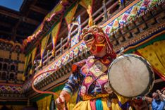 Monk in colorful mask dancing at yearly Paro Tsechu festival in Bhutan © mbrand85/Shutterstock