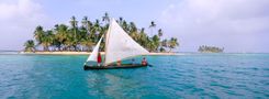 Cuna Indians Sailing Traditional Sailboat Among Small Islands