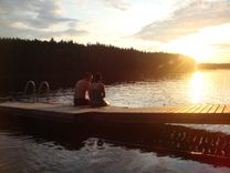 Couple on lake at sunset in Finland, honeymoon tips