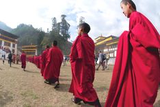 Monks walk in Monastery, Bhutan, Copyright Margot Raggett
